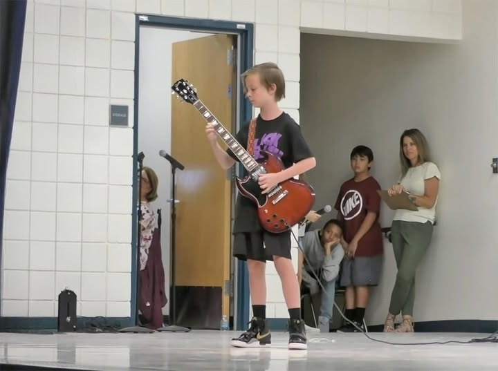 At the school talent show, 11-year-old Julian rocks the stage with an AC/DC performance.